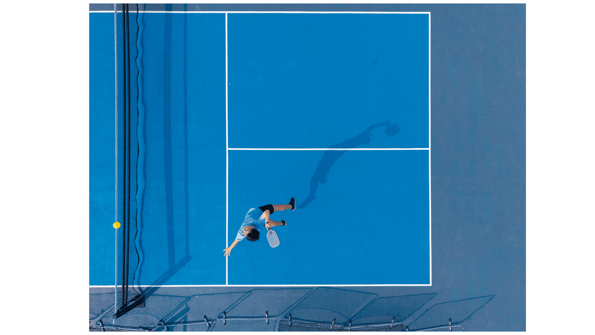 Player reaching for a shot on a blue court