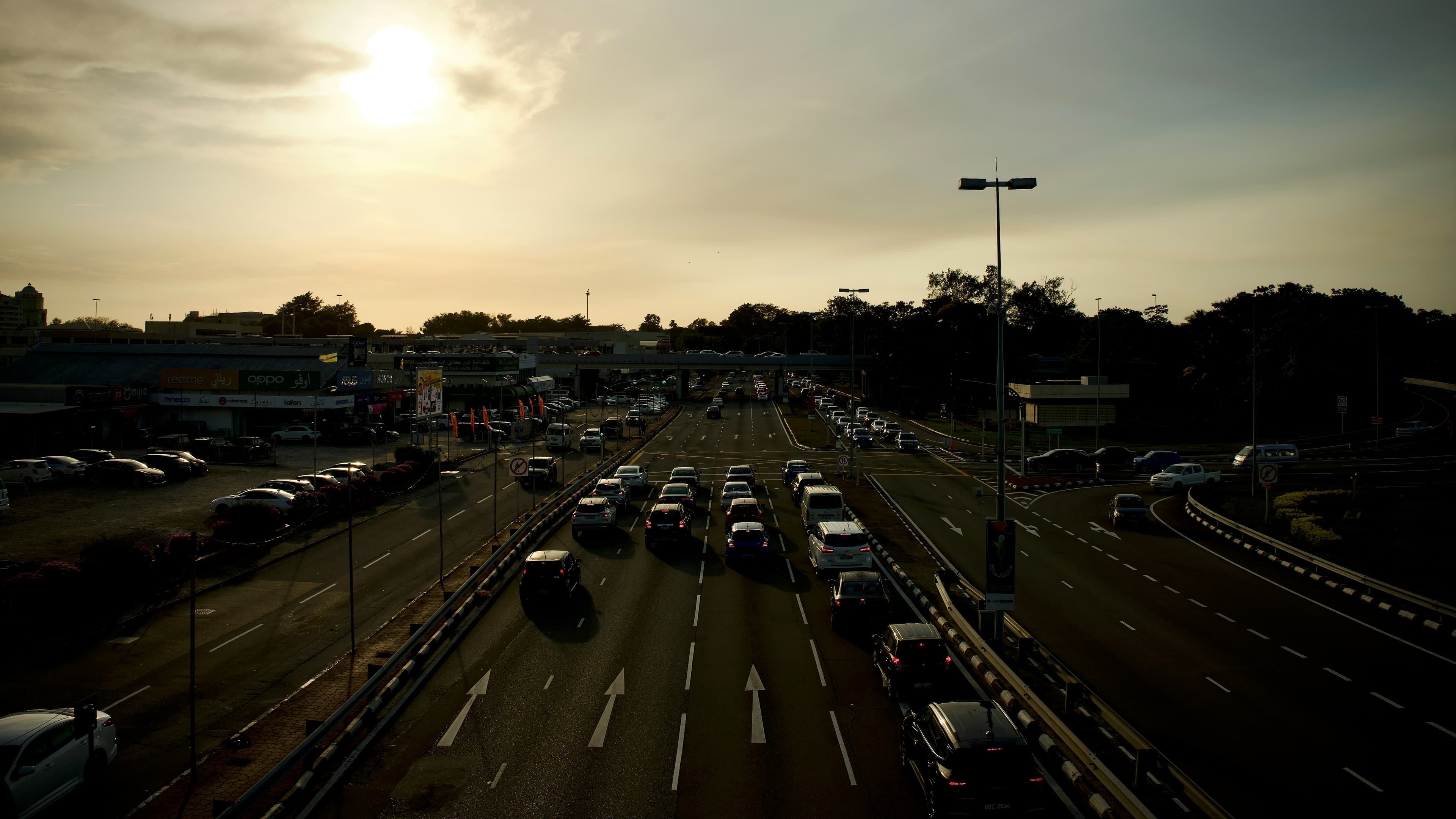 Sunset view of a divided road and nearby shops