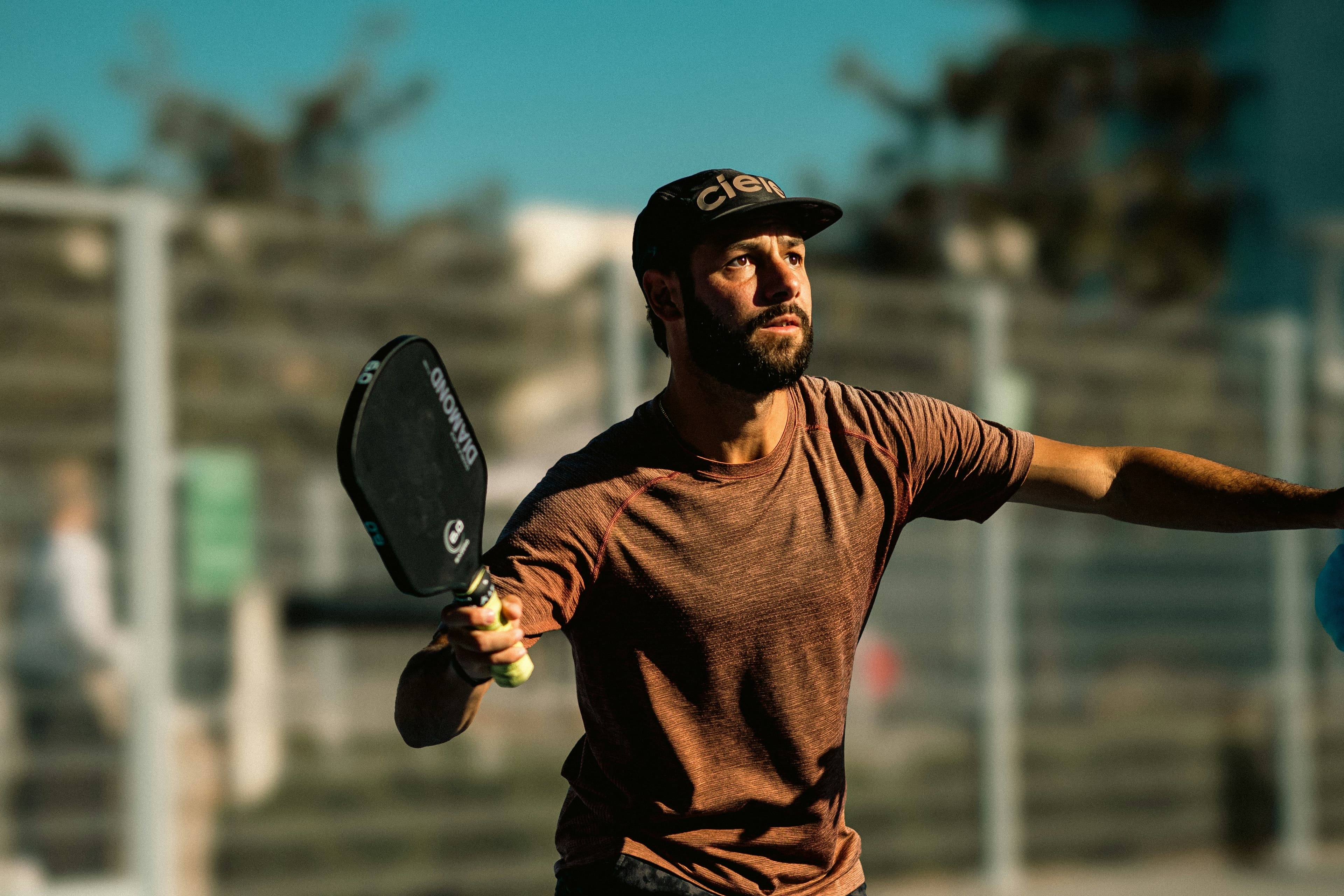 Player holding a paddle outdoors